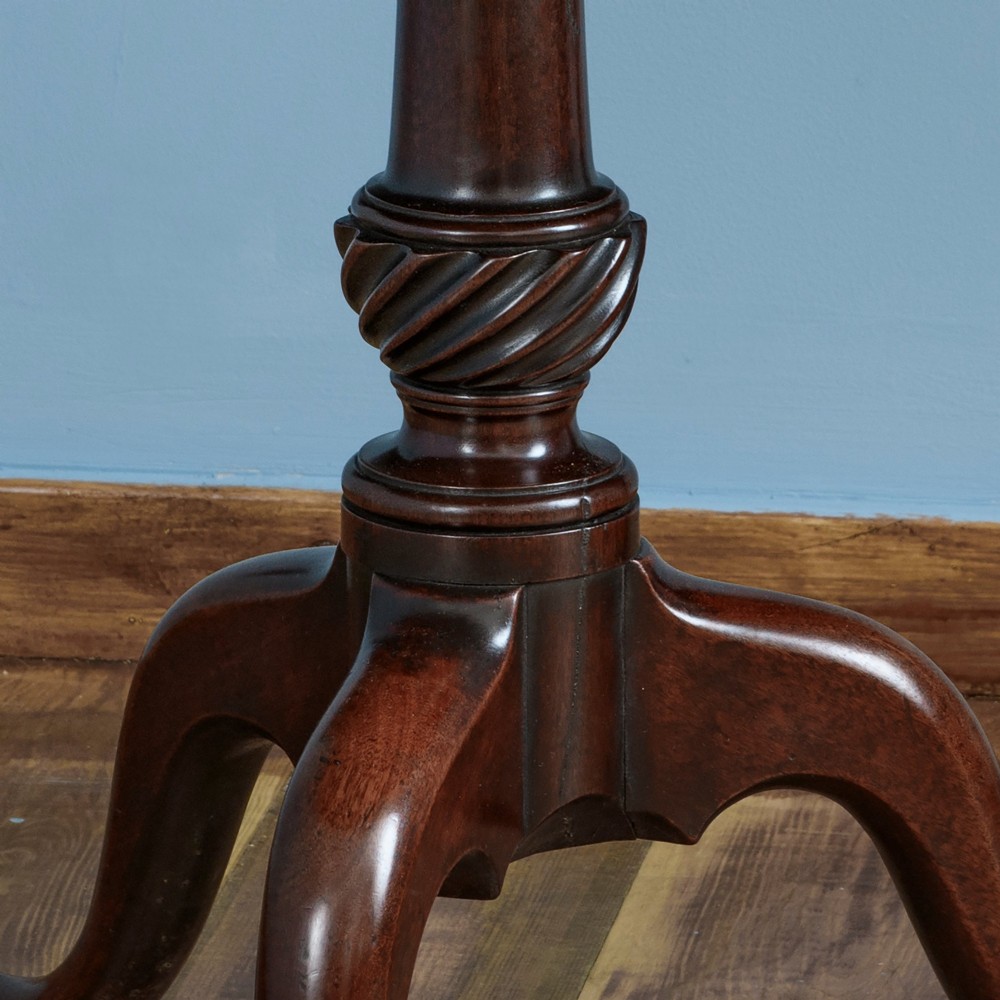 A George III dark mahogany two-tier dumb waiter with graduated circular trays, spiral turned central stem, and tripod cabriole legs. View II