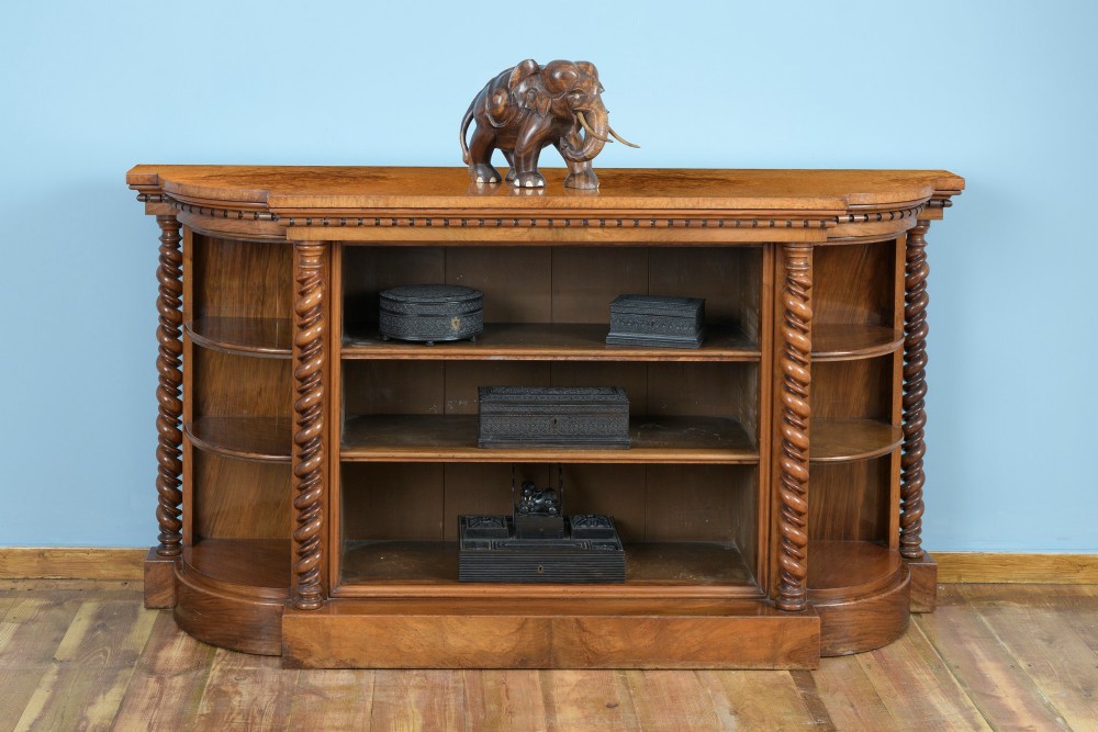 A mid-19th-century burr walnut and amboyna side cabinet featuring open shelves, barley-twist column accents, and a curved breakfront silhouette. View II