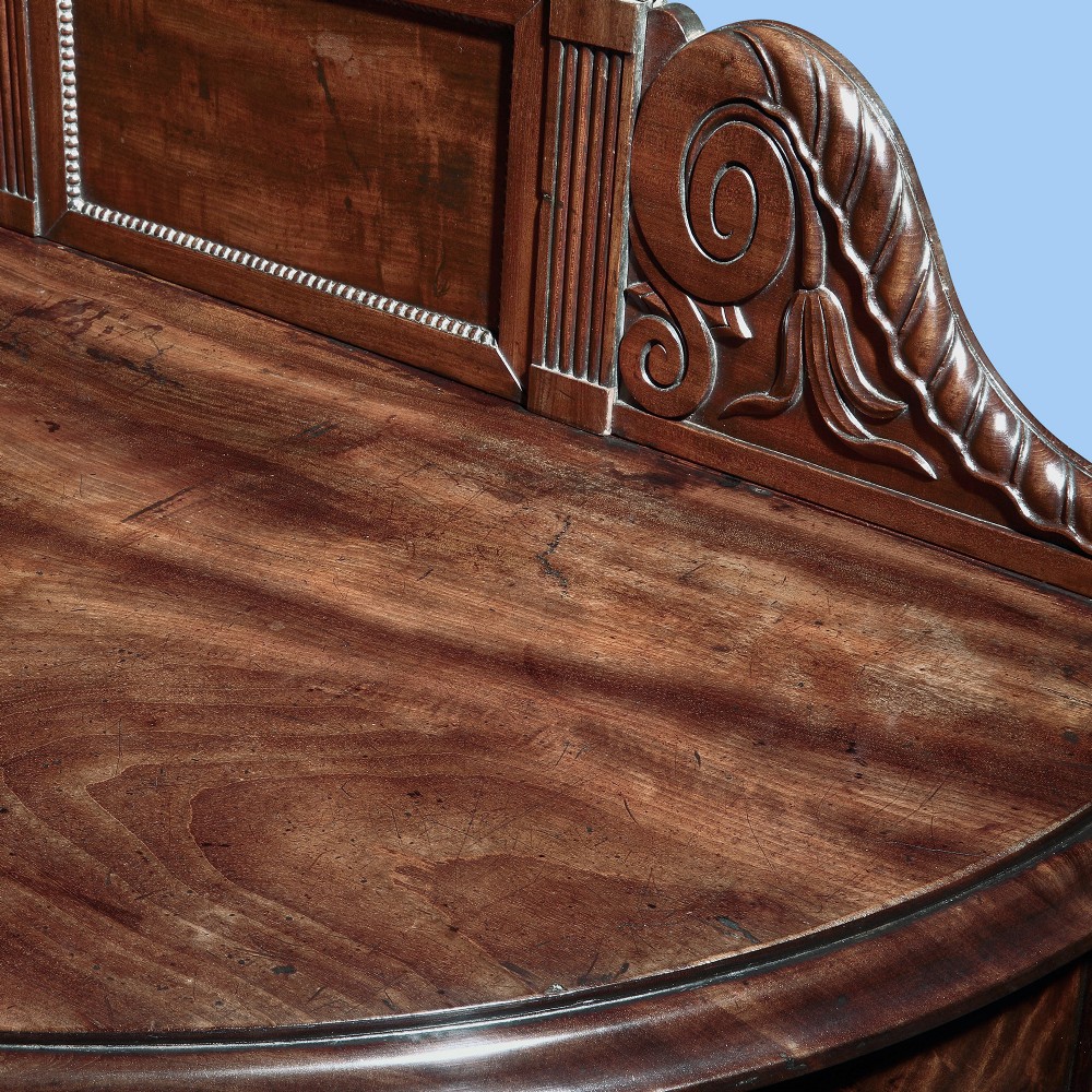 A grand George IV flame mahogany serving table featuring six reeded turned legs and a carved back gallery. View II