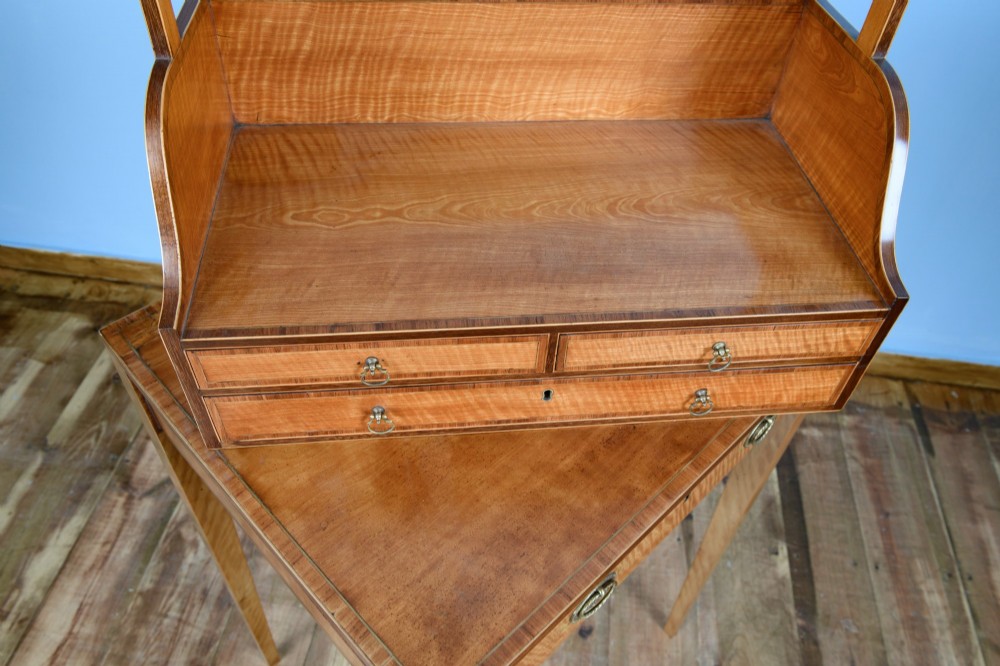 An 18th-century Georgian satinwood cheveret writing table featuring slender square tapered legs, brass ring pulls, and a upper cabinet with an integrated handle. View VIII