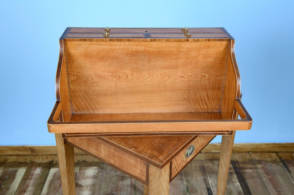 An 18th-century Georgian satinwood cheveret writing table featuring slender square tapered legs, brass ring pulls, and a upper cabinet with an integrated handle. View IX
