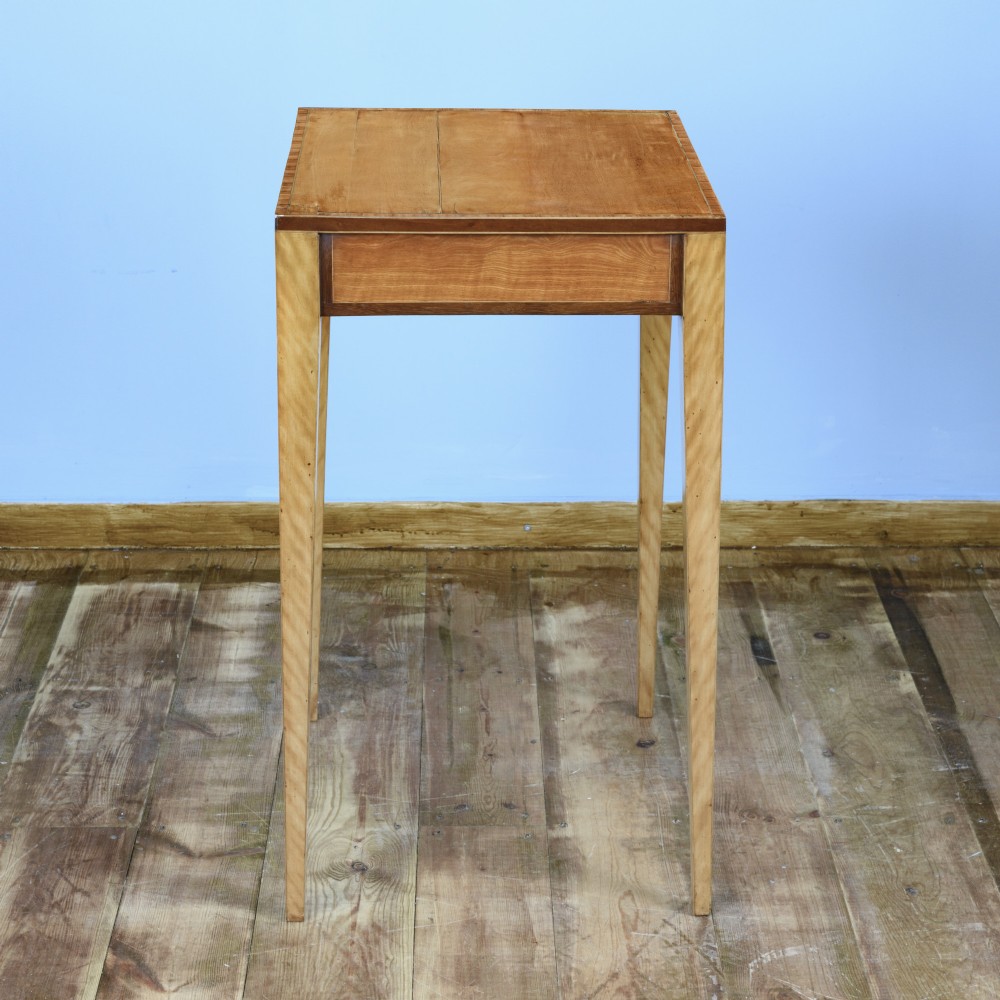 An 18th-century Georgian satinwood cheveret writing table featuring slender square tapered legs, brass ring pulls, and a upper cabinet with an integrated handle. View XIII