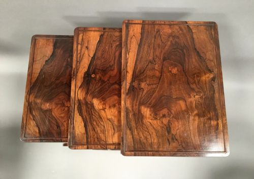 fig 1. A set of three graduated Regency rosewood nesting tables featuring turned twin-spindle legs and trestle feet.