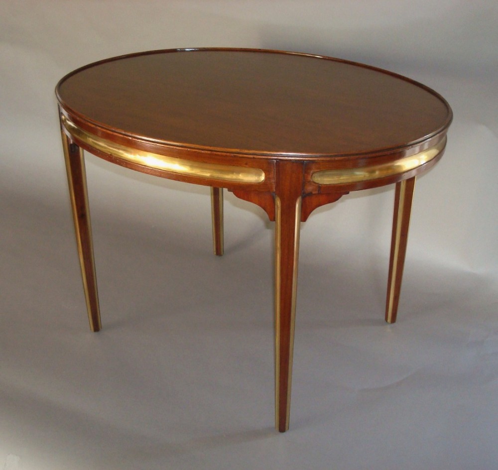 Early 20th century oval mahogany and brass low occasional table