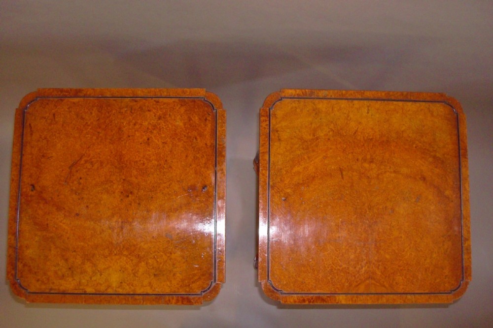 A pair of tall Regency occasional tables featuring square amboyna tops, ebonised turned legs with gilt accents, and concave undertiers. View IV