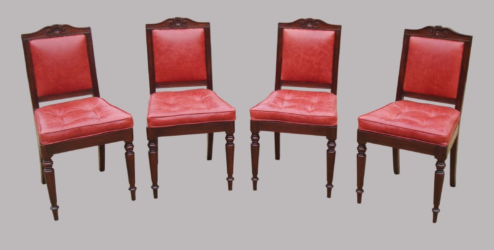 A set of four Regency mahogany side chairs featuring carved crest rails, red leather buttoned upholstery, and turned front legs. View III