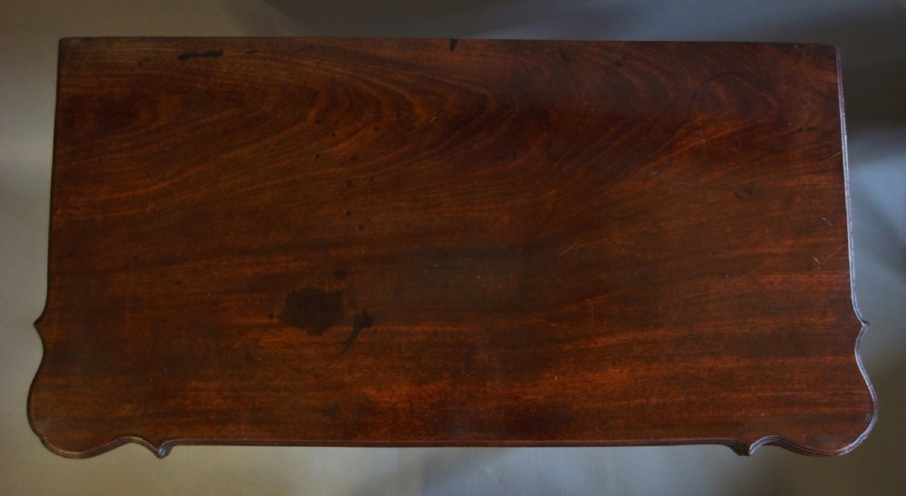A George III mahogany card table with a fold-over top, a single frieze drawer, carved cabriole legs, and claw and ball feet. View IV