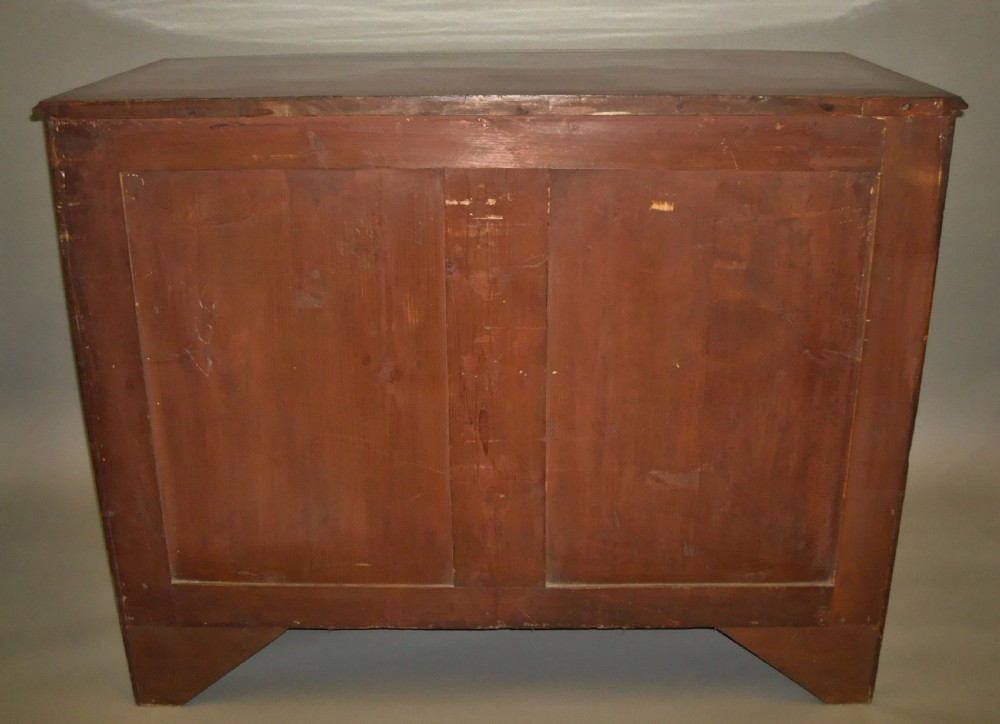 A George III mahogany bowfront chest of drawers featuring four graduated drawers with brass handles and splay feet. View VIII