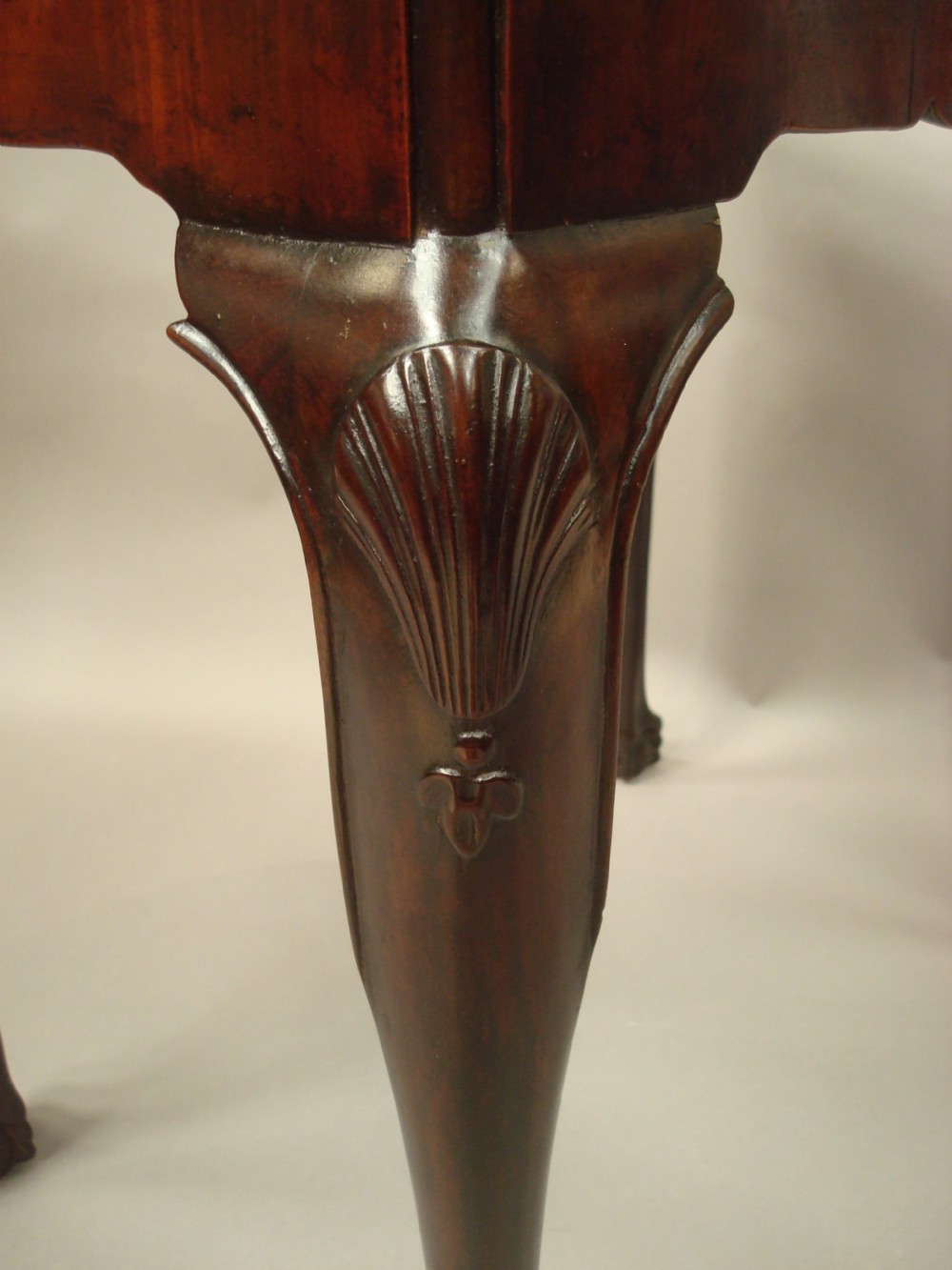 A George II mahogany silver table featuring carved cabriole legs ending in ball and claw feet, shell-carved knees, and a shaped apron. View VI