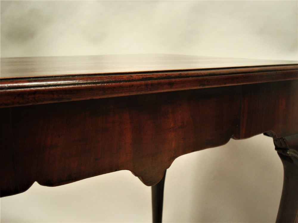 A George II mahogany silver table featuring carved cabriole legs ending in ball and claw feet, shell-carved knees, and a shaped apron. View VIII