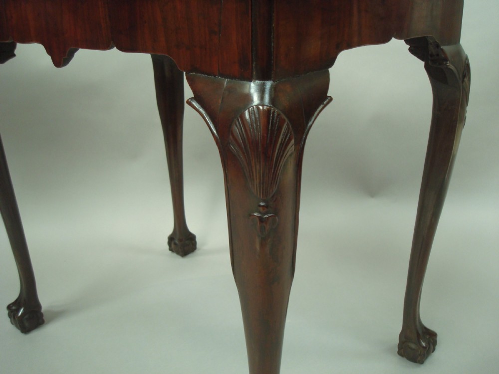 A George II mahogany silver table featuring carved cabriole legs ending in ball and claw feet, shell-carved knees, and a shaped apron. View IX