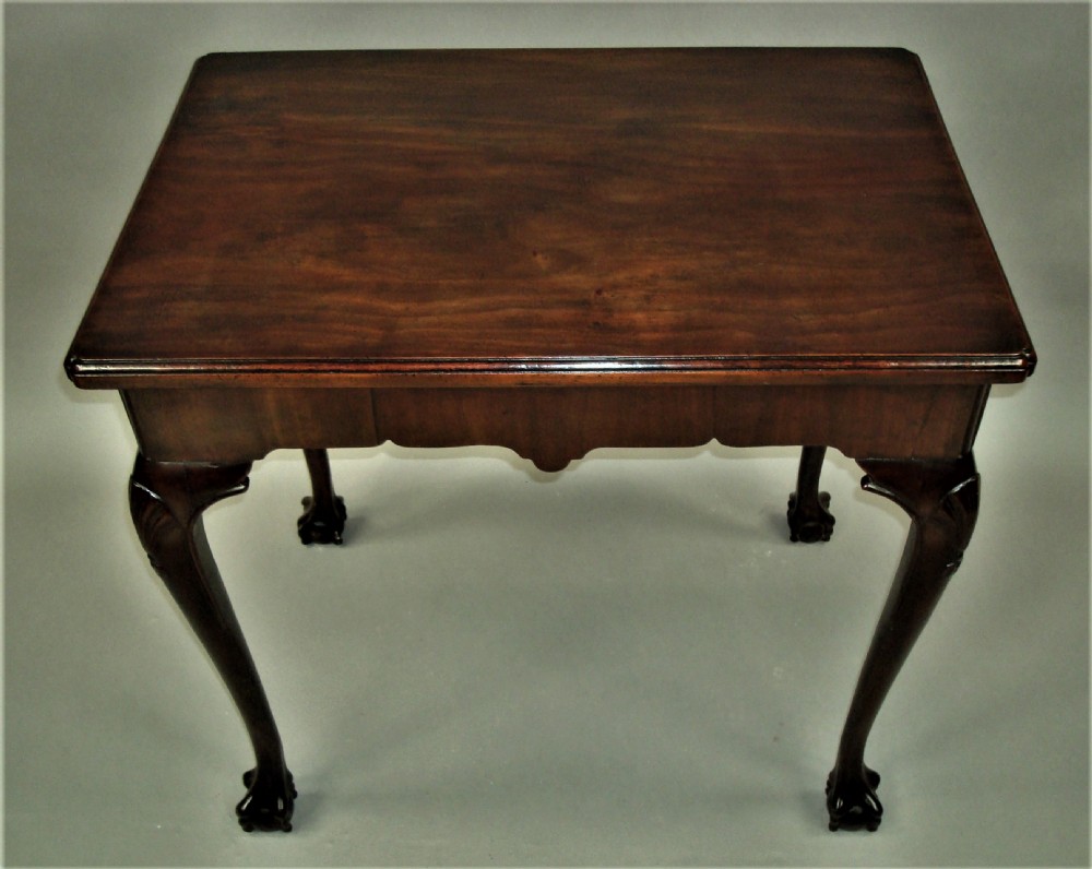 A George II mahogany silver table featuring carved cabriole legs ending in ball and claw feet, shell-carved knees, and a shaped apron. View XII