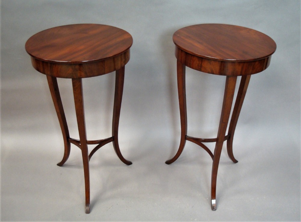 A pair of matching nineteenth-century round mahogany occasional tables featuring shaped legs and circular tops against a neutral background. View III