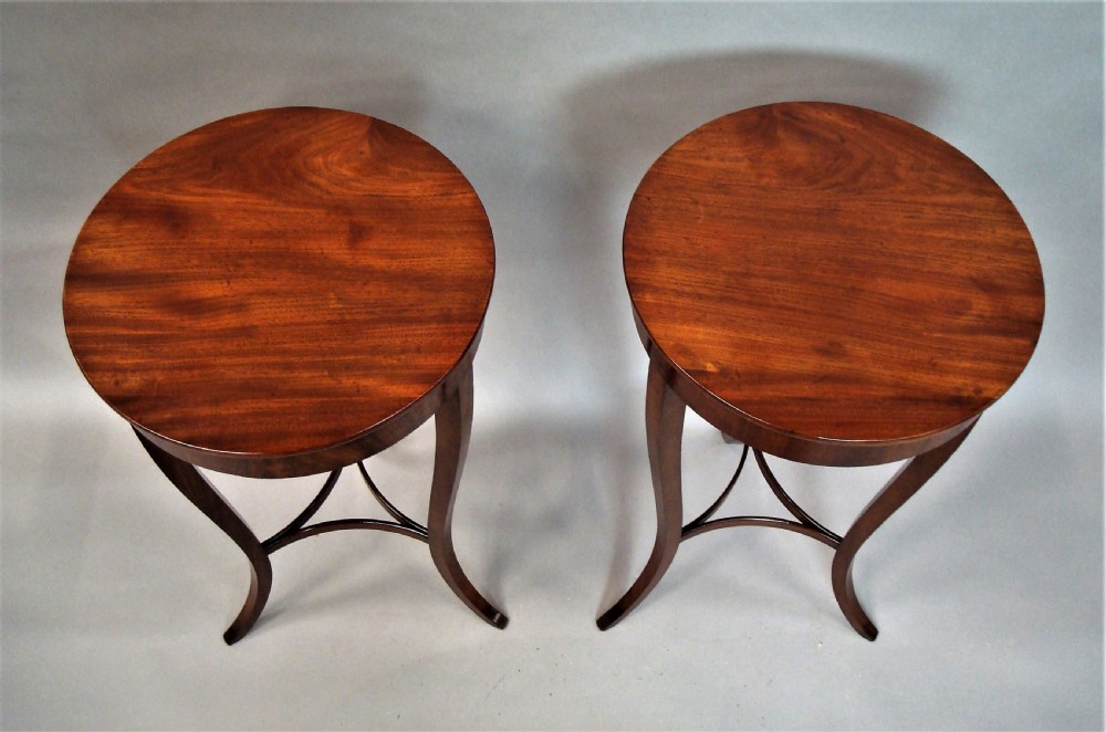 A pair of matching nineteenth-century round mahogany occasional tables featuring shaped legs and circular tops against a neutral background. View IV