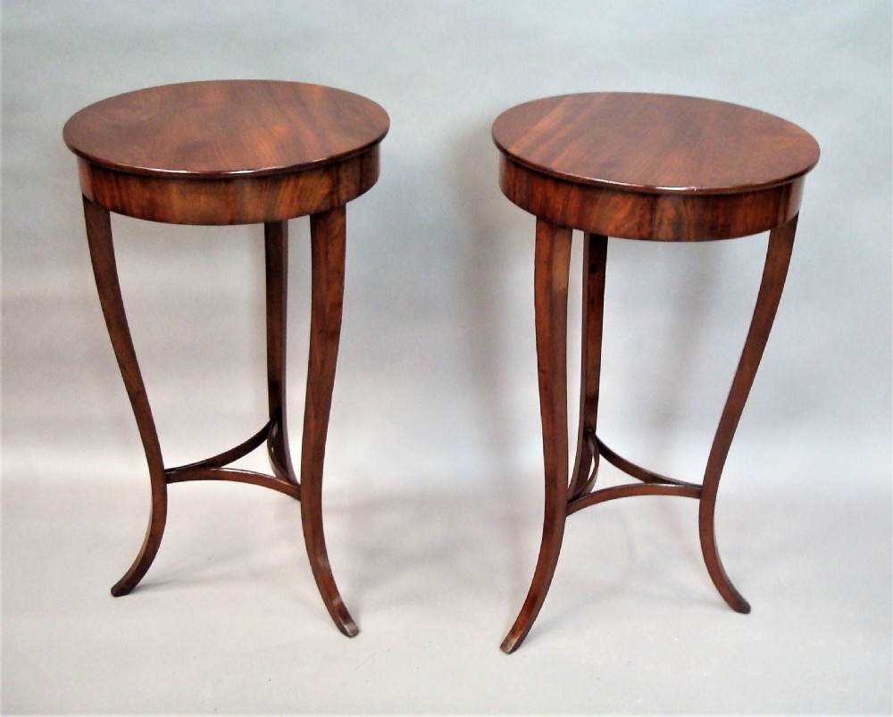 A pair of matching nineteenth-century round mahogany occasional tables featuring shaped legs and circular tops against a neutral background. View VI