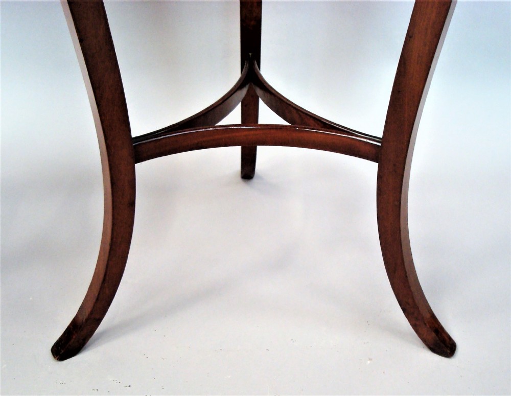 A pair of matching nineteenth-century round mahogany occasional tables featuring shaped legs and circular tops against a neutral background. View IX