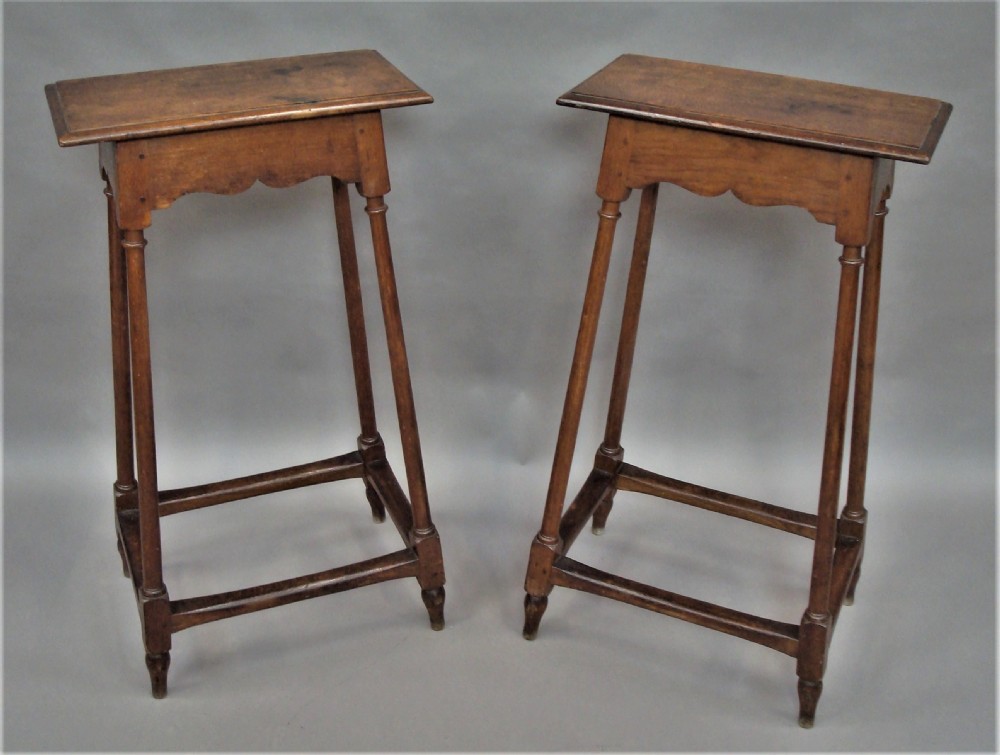 A pair of tall 19th-century oak stands featuring rectangular tops, scalloped aprons, slender turned legs, and low box stretchers. View VIII