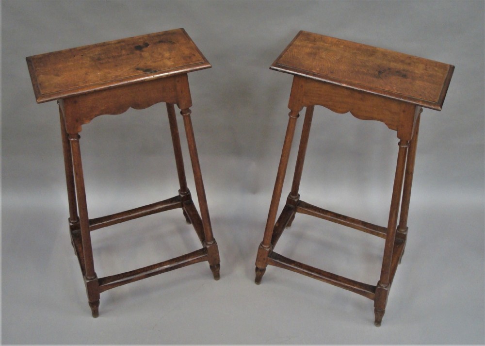 A pair of tall 19th-century oak stands featuring rectangular tops, scalloped aprons, slender turned legs, and low box stretchers. View IX