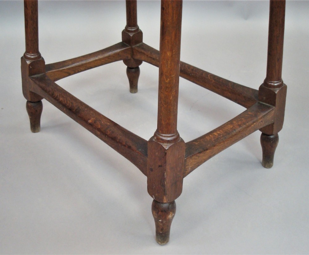 A pair of tall 19th-century oak stands featuring rectangular tops, scalloped aprons, slender turned legs, and low box stretchers. View XII