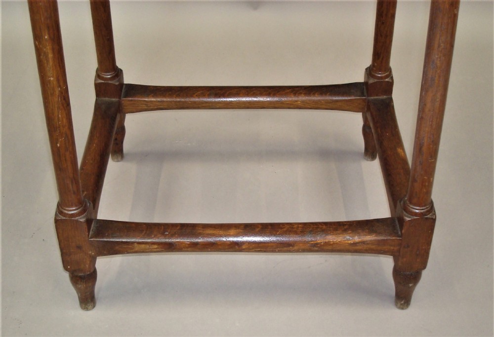 A pair of tall 19th-century oak stands featuring rectangular tops, scalloped aprons, slender turned legs, and low box stretchers. View XV