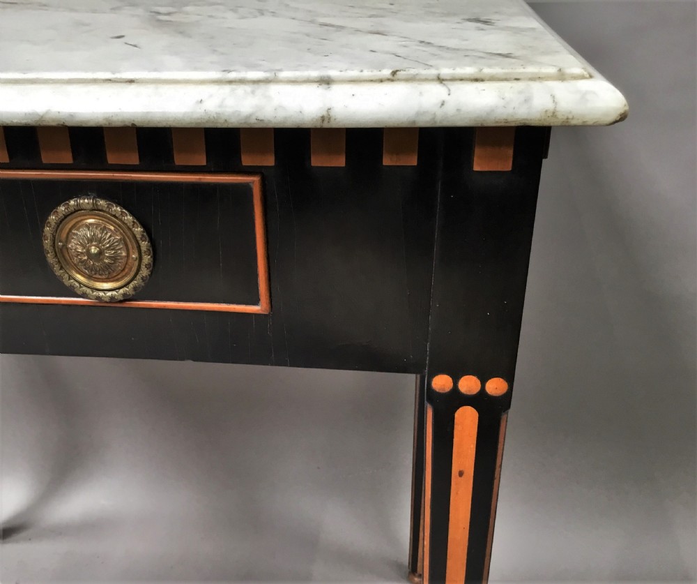 An early nineteenth-century Dutch Neoclassical side table constructed with ebonised timber, satinwood inlay, a rectangular white marble top, and tapered square legs. View VIII