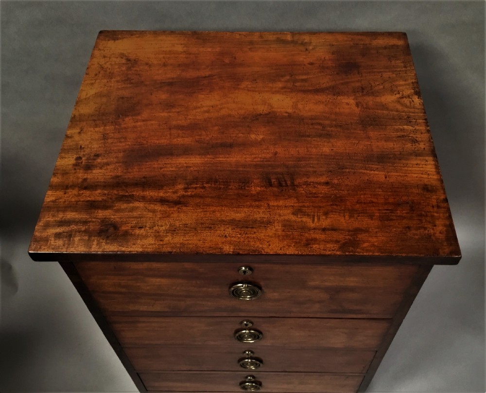 An antique Regency mahogany secretaire chest of drawers with brass ring handles and a solid plinth base. View VI