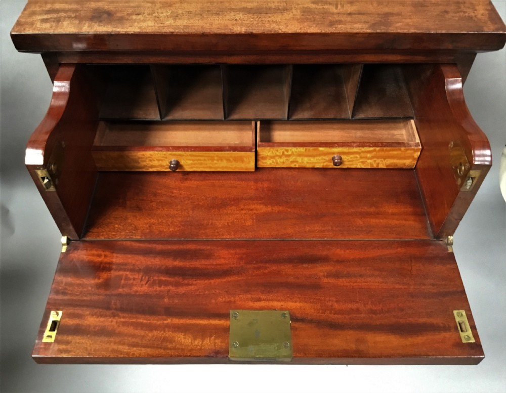 An antique Regency mahogany secretaire chest of drawers with brass ring handles and a solid plinth base. View IX