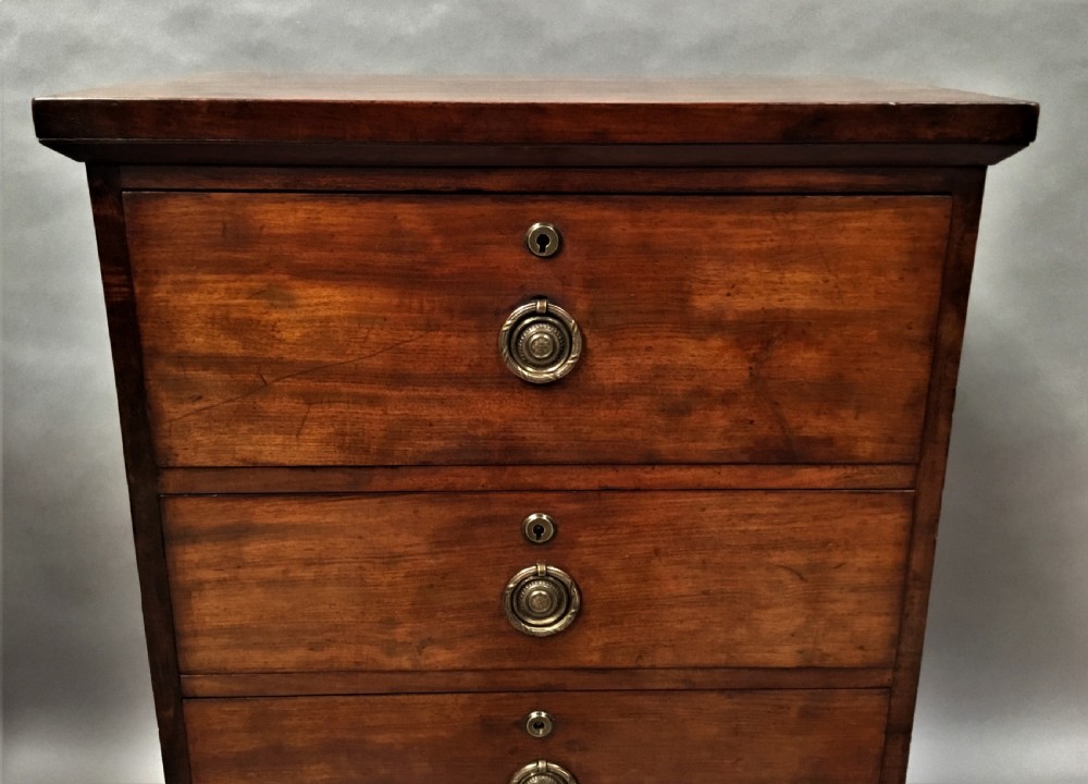An antique Regency mahogany secretaire chest of drawers with brass ring handles and a solid plinth base. View XIV