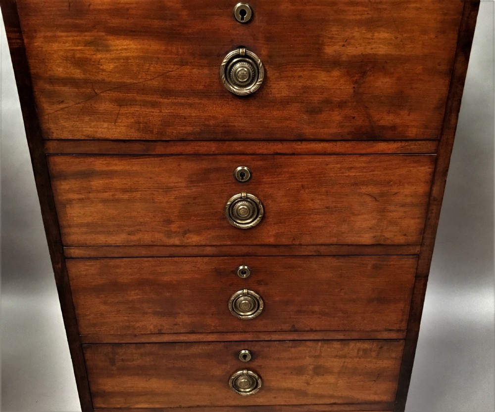 An antique Regency mahogany secretaire chest of drawers with brass ring handles and a solid plinth base. View XV