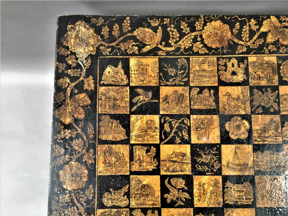 A square black Regency occasional table with an inlaid chessboard top and detailed floral penwork patterns along the frieze and straight legs. View VIII