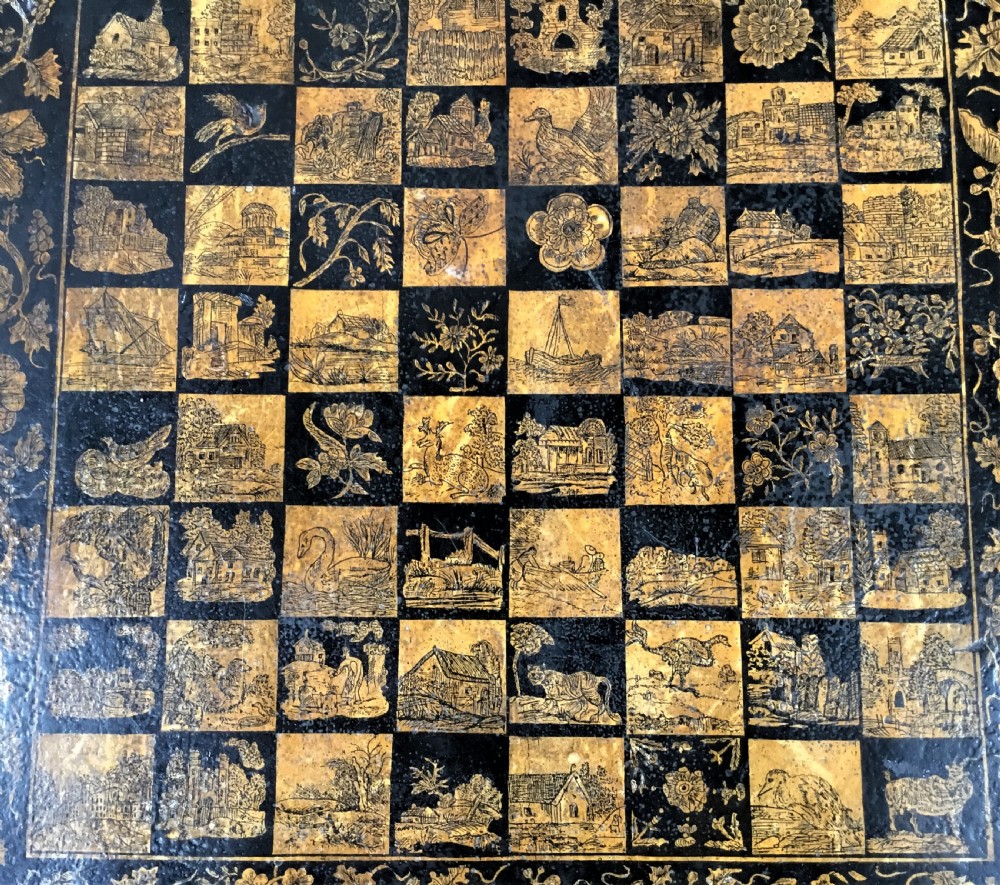 A square black Regency occasional table with an inlaid chessboard top and detailed floral penwork patterns along the frieze and straight legs. View XII