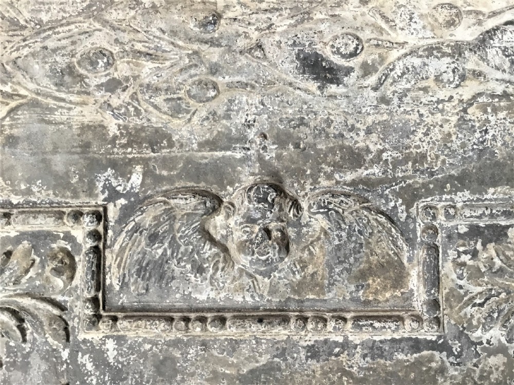A square cast lead panel dated 1765 featuring a central wreath with monogram PP, acanthus scroll borders, cherub detail, and side relief motifs of dolphins. View XII