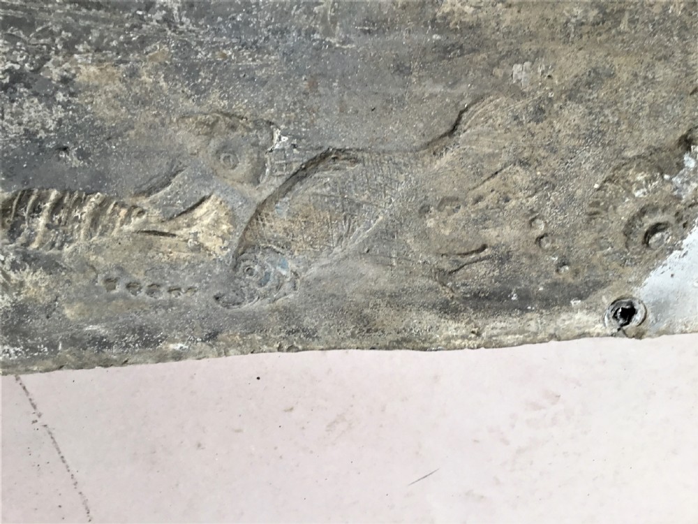 A square cast lead panel dated 1765 featuring a central wreath with monogram PP, acanthus scroll borders, cherub detail, and side relief motifs of dolphins. View XVI