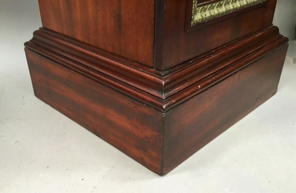 A tall mahogany Regency pedestal cabinet featuring cast brass leaf borders and a single panelled door on a plinth base. View XIII