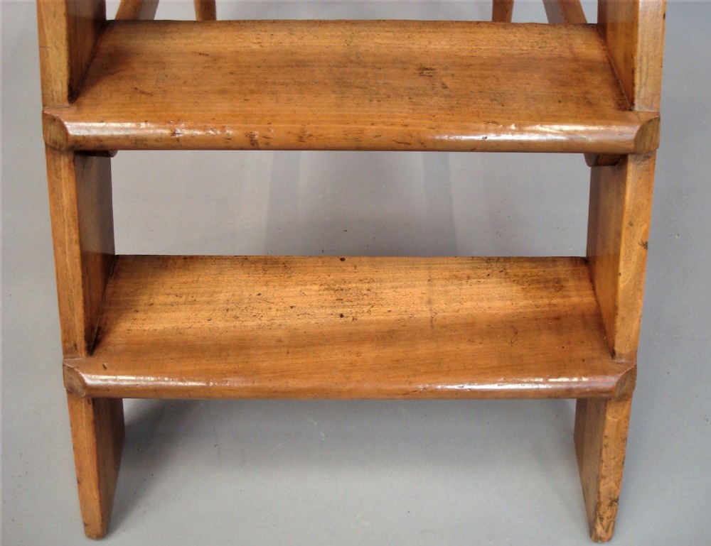 A nineteenth-century English fruitwood library ladder with four steps, a top platform, and turned back legs. View XII