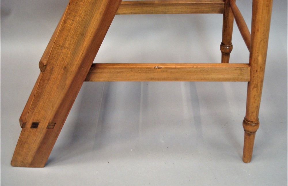 A nineteenth-century English fruitwood library ladder with four steps, a top platform, and turned back legs. View XVII