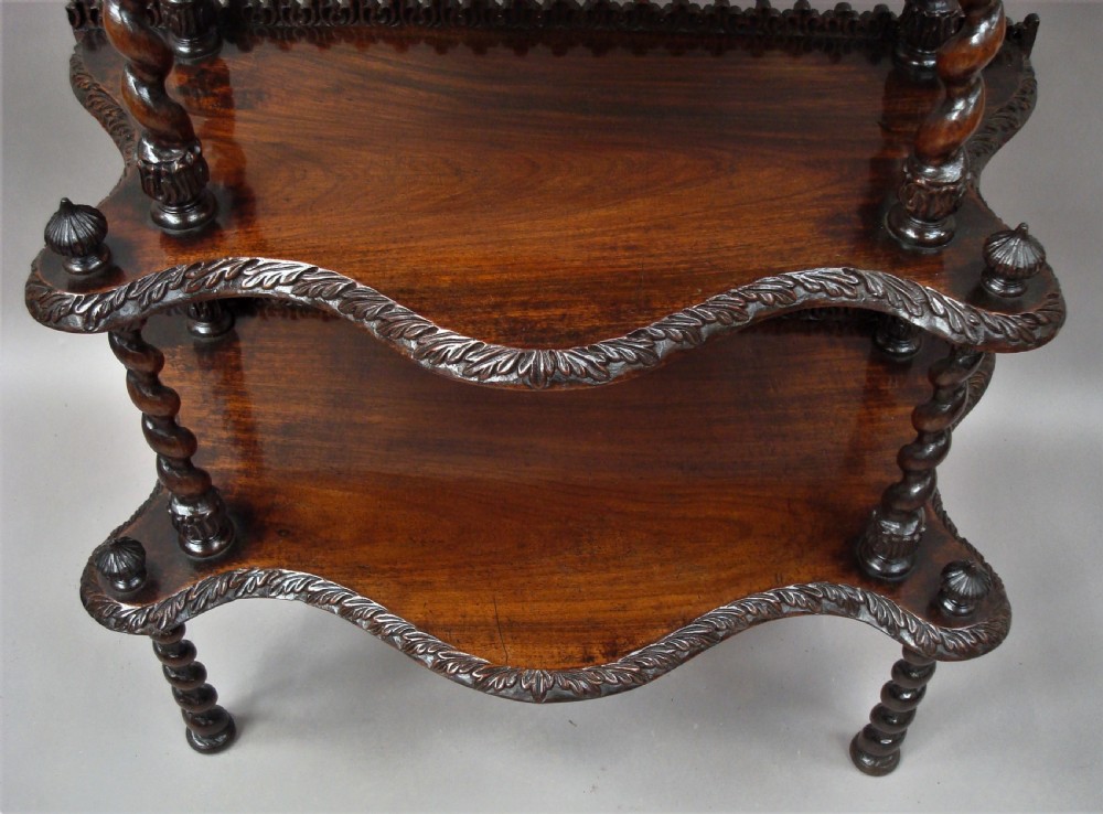 A mid-nineteenth-century dark brown padouk wood whatnot featuring five open tiered shelves supported by barley-twist columns and carved decorative rims. View IX