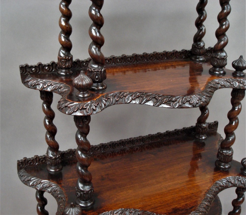 A mid-nineteenth-century dark brown padouk wood whatnot featuring five open tiered shelves supported by barley-twist columns and carved decorative rims. View XIII