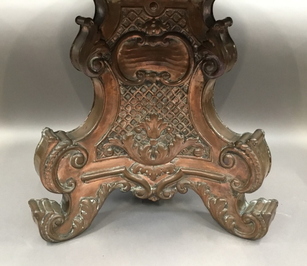 A round black marble low centre table featuring light veining, supported by an ornate copper pedestal base with scrolled feet and carved motifs. View VIII