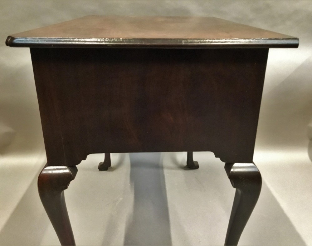An 18th-century George II mahogany lowboy table featuring three drawers with brass drop handles, a shaped apron, and four cabriole legs with pad feet. View XIV
