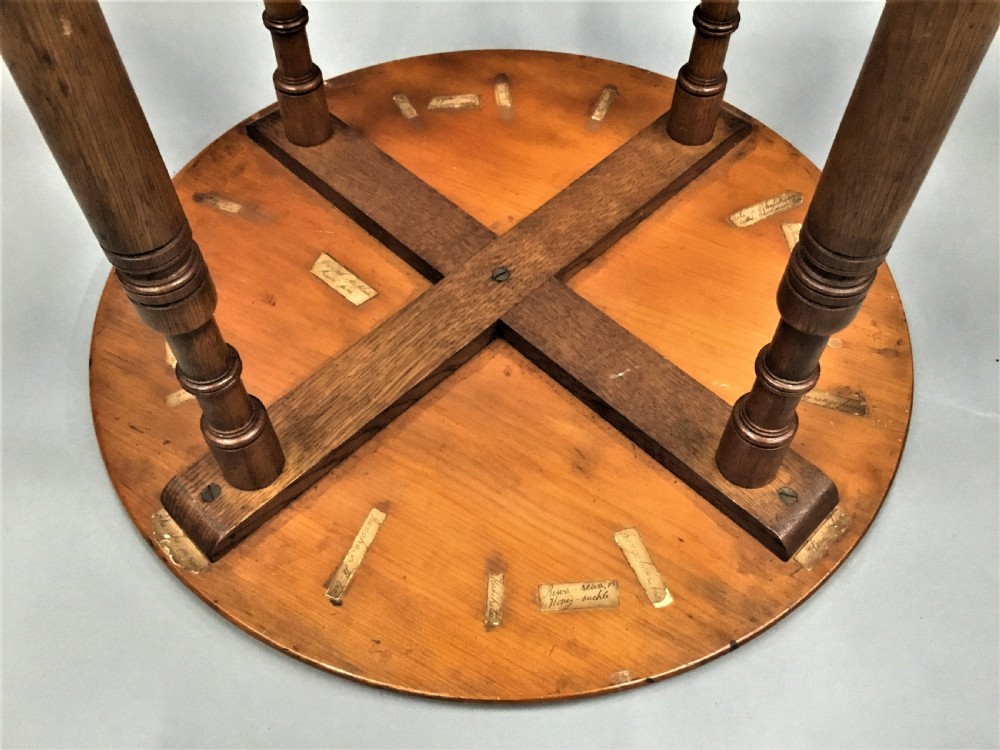 A nineteenth-century circular specimen wood side table featuring a geometric starburst inlaid tabletop supported by four turned legs and an X-frame cross stretcher. View III