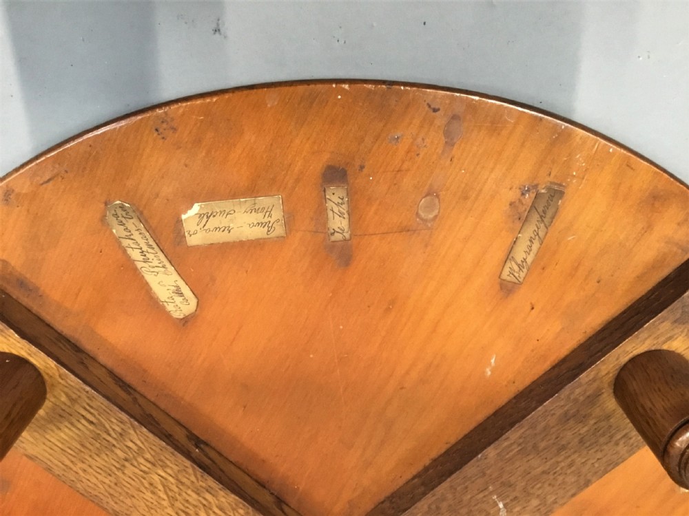 A nineteenth-century circular specimen wood side table featuring a geometric starburst inlaid tabletop supported by four turned legs and an X-frame cross stretcher. View XI