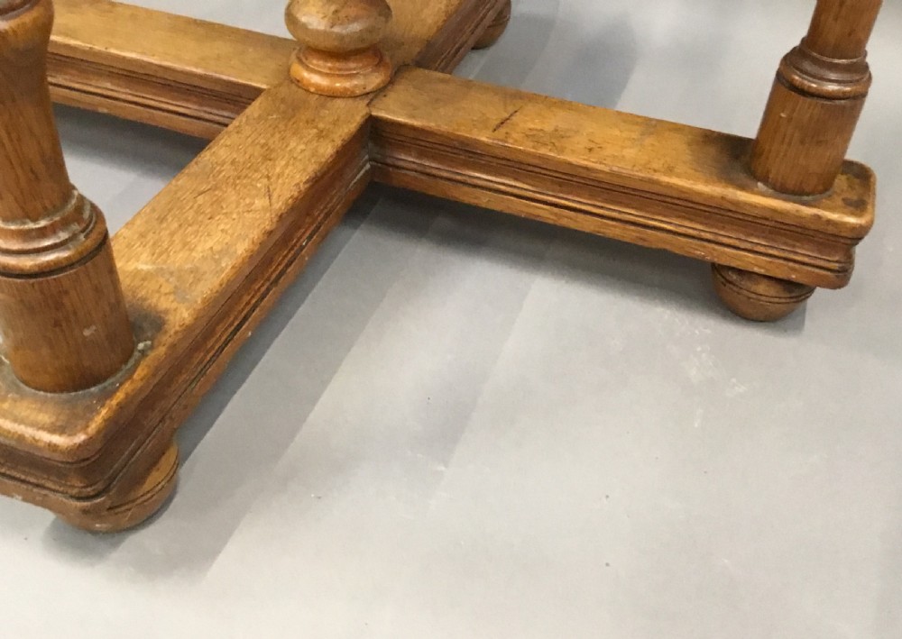 A nineteenth-century circular specimen wood side table featuring a geometric starburst inlaid tabletop supported by four turned legs and an X-frame cross stretcher. View XVII