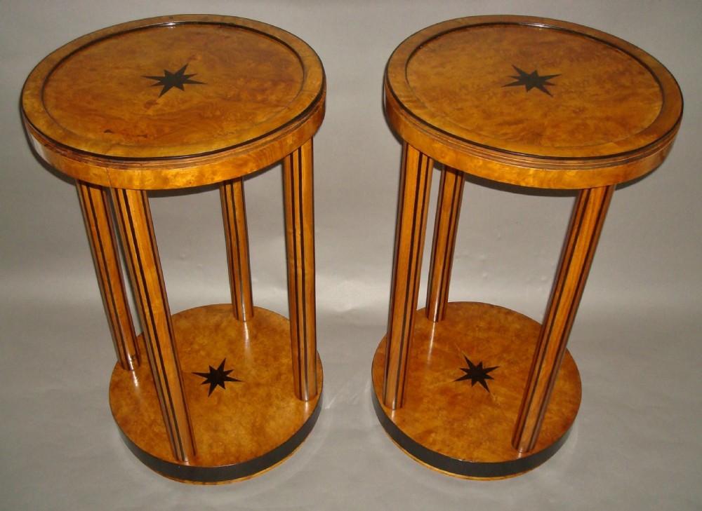 A pair of circular burr elm occasional tables featuring inlaid ebony star motifs, slender vertical legs with black stringing, and an ebony-banded lower tier. View II