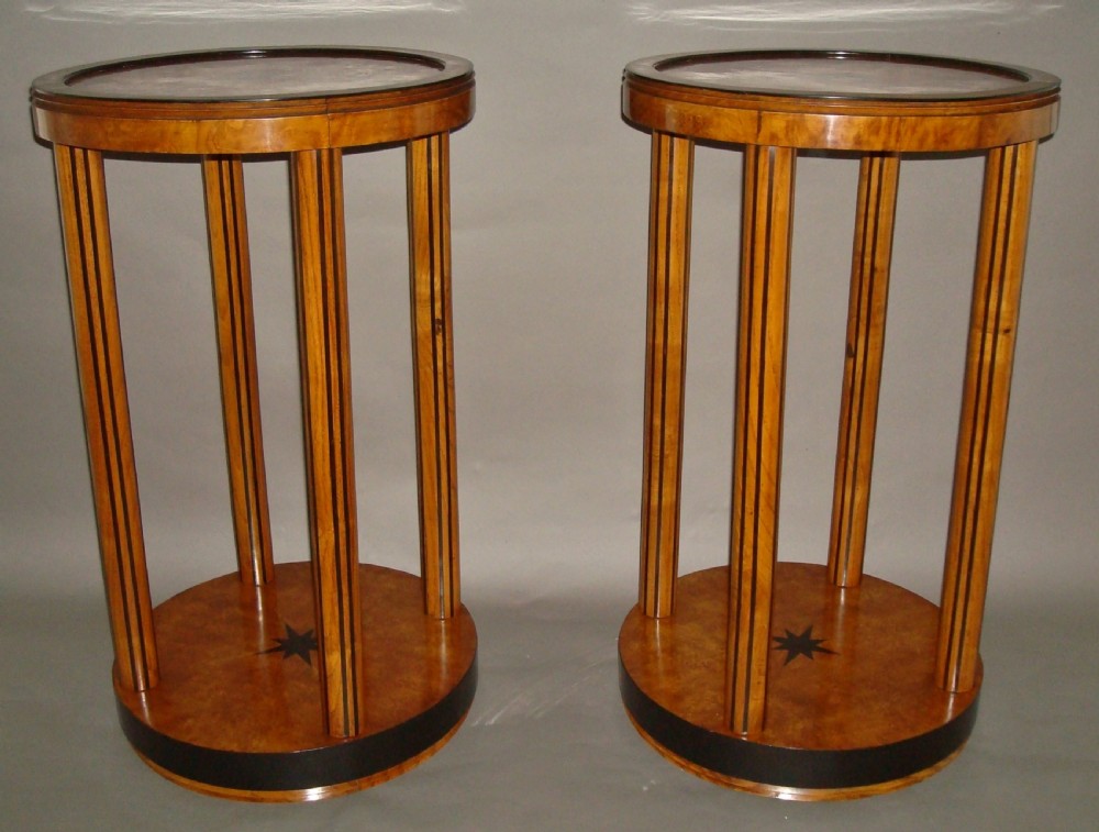A pair of circular burr elm occasional tables featuring inlaid ebony star motifs, slender vertical legs with black stringing, and an ebony-banded lower tier. View III