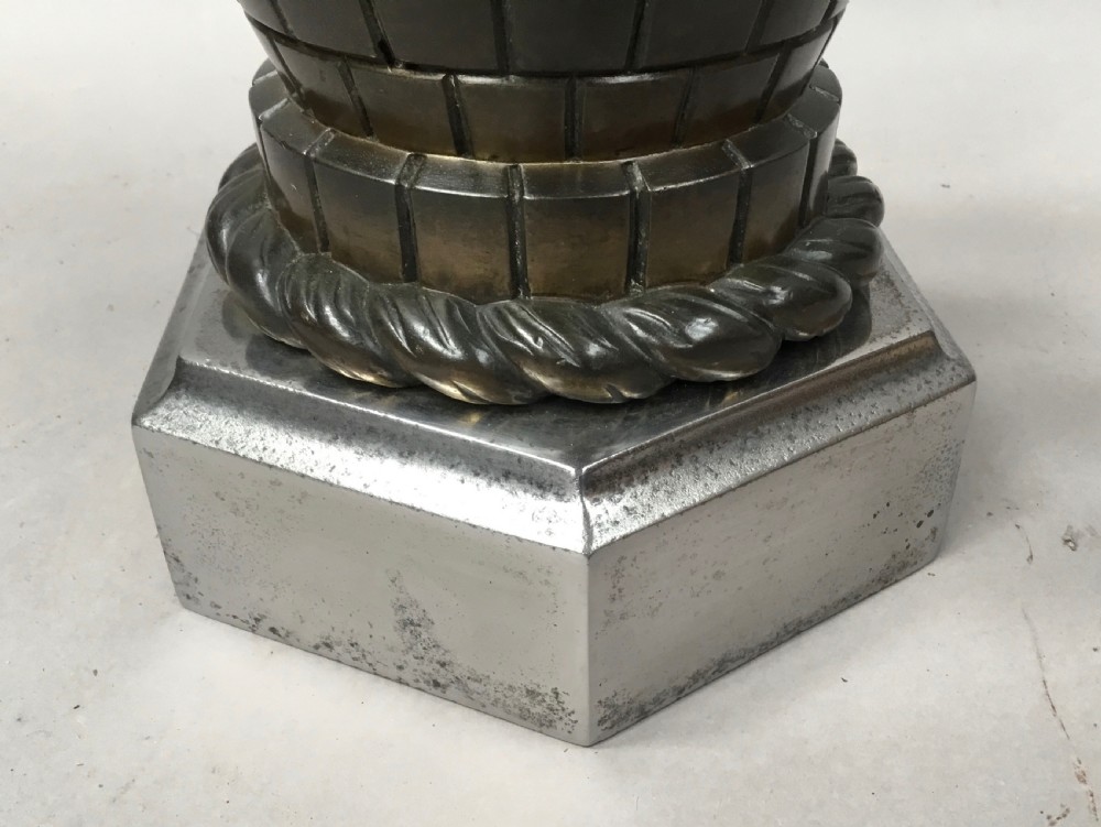 A pair of nineteenth-century bronze door stops featuring a heraldic lion paw holding a ball above a castellated wall, resting on heavy hexagonal bases. View XV