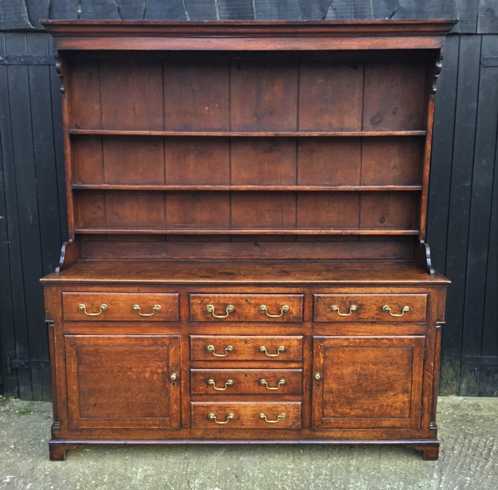 Georgian oak dresser with cupboard base and original rack