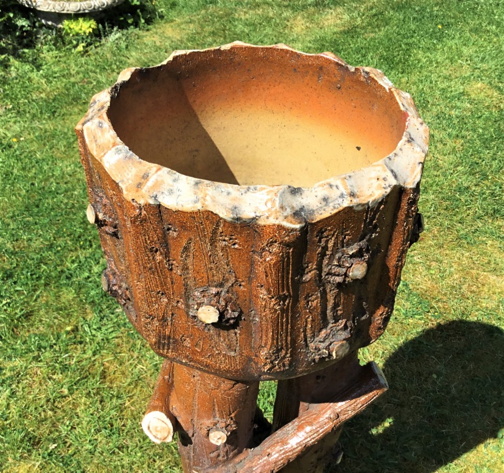 A 19th-century brown earthenware jardiniere and matching stand crafted in a naturalistic faux bois log and branch motif. View XII
