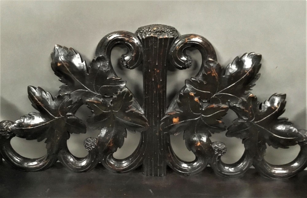 A 19th-century dark carved wood hall seat supported by two sculptural standing bear figures with a carved leaf motif backrest. View XV