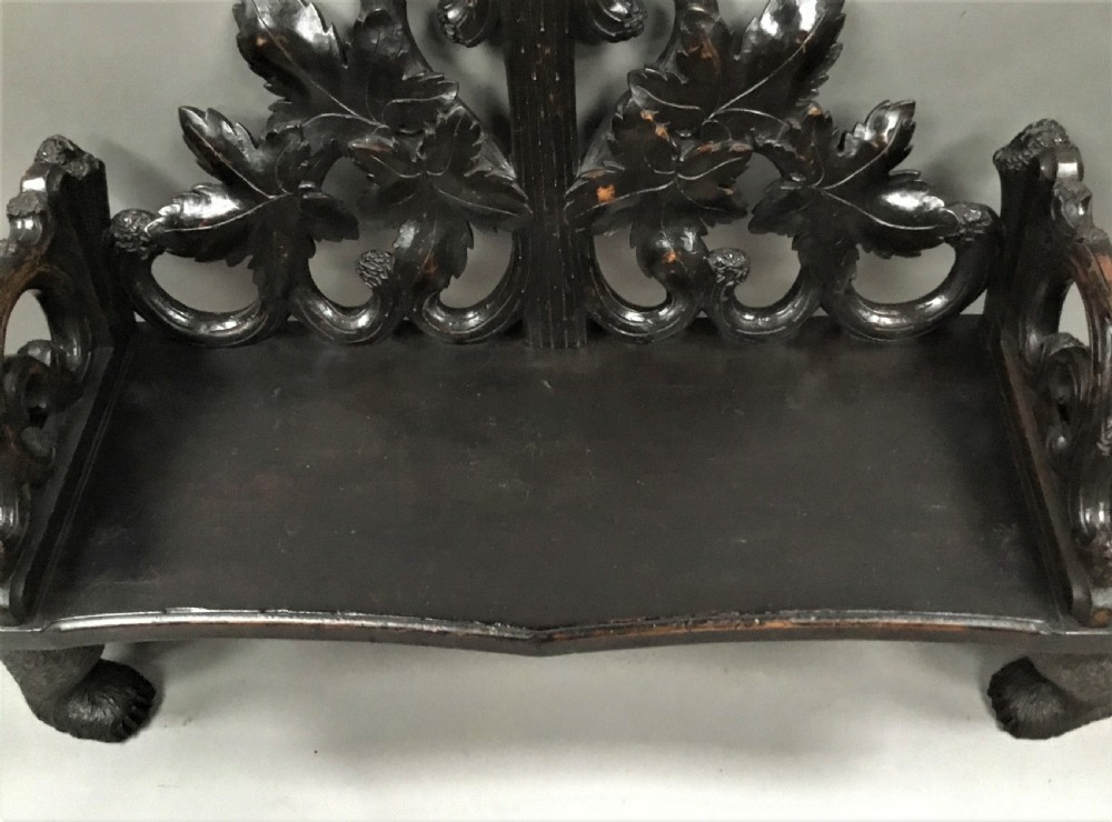 A 19th-century dark carved wood hall seat supported by two sculptural standing bear figures with a carved leaf motif backrest. View XIX